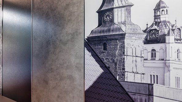 Ein historisches Gebäude mit markanten Türmen und Uhren, das in Schwarz-Weiß dargestellt ist, vermittelt ein nostalgisches Gefühl.